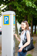 Young woman paying for parking