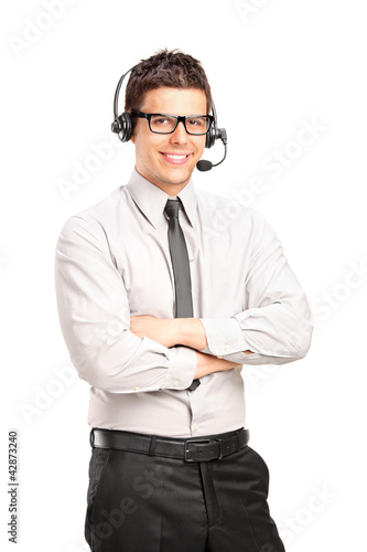 Photo: A male customer service operator wearing a headset A male customer service operator wearing a headset
