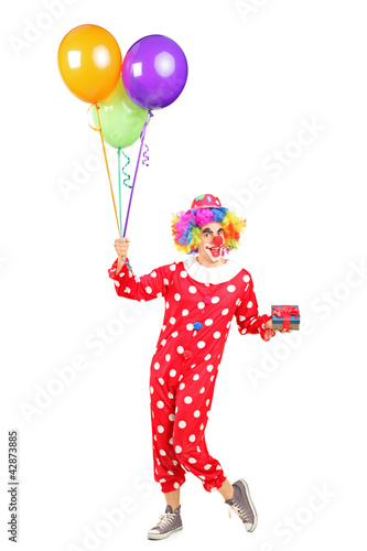 Photo: Male clown, happy joyful expression on face, with a bunch of bal Male clown, happy joyful expression on face, with a bunch of bal