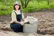 woman fertilizes  soil