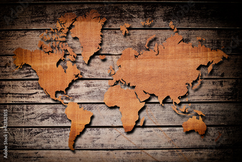 Photo: World map carving on wood plank. World map carving on wood plank.