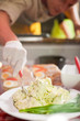 Working in a butchers shop with cream cheese