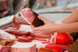 Display in a butchers shop, woman with ham