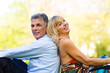 Photo: Senior couple during spring on a meadow in the city Senior couple during spring on a meadow in the city