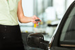 woman with car key opening new or rental auto