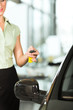 woman with car key opening new or rental auto