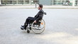 Business man rolling in wheelchair