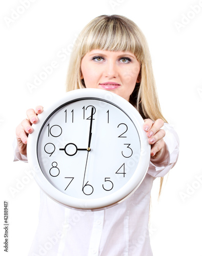 Photo: Young business woman holding clock isolated on white Young business woman holding clock isolated on white