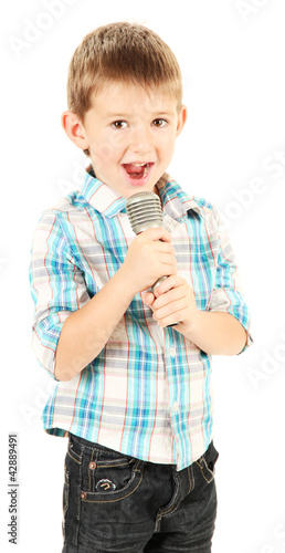 Photo: funny little boy with microphone, isolated on white funny little boy with microphone, isolated on white