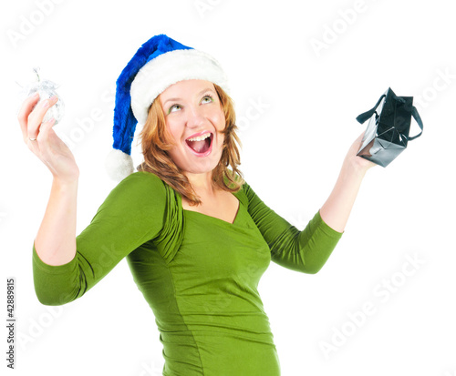 Photo: Beautiful happy woman looking inside black shopping gift bag loo Beautiful happy woman looking inside black shopping gift bag loo