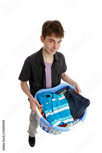 Foto: Teenager holding a basket of laundry Teenager holding a basket of laundry