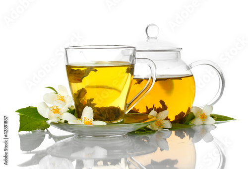Photo: green tea with jasmine in cup and teapot isolated on white green tea with jasmine in cup and teapot isolated on white