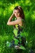 brunette sitting on green grass