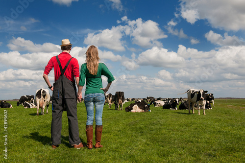 Foto: Typical Dutch landscape with farmer couple and cows Typical Dutch landscape with farmer couple and cows