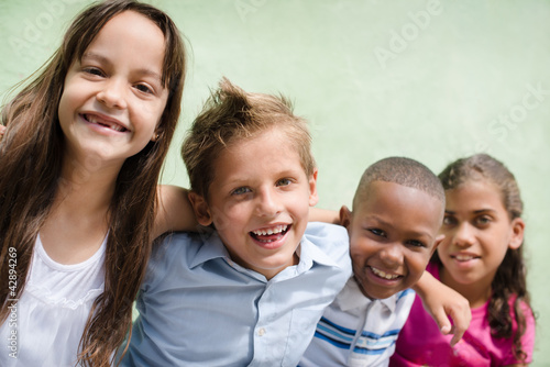 Photo: happy children hugging, smiling and having fun happy children hugging, smiling and having fun