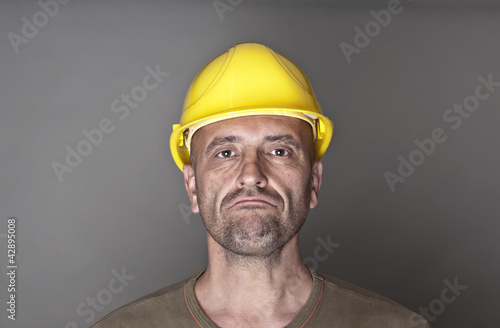 Photo: Unhappy, sceptical worker Unhappy, sceptical worker
