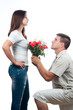 Handsome young man offering bouquet of roses to his girlfriend