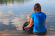 mother and baby sitting on wooden dock