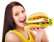 Woman holding hamburger.