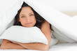 Smiling woman hugging a pillow