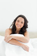 Close-up of an attractive brunette sitting in her bed