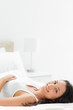 Close-up of a delighted woman lying in her bed