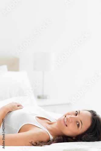 Photo: Close-up of a delighted woman lying in her bed Close-up of a delighted woman lying in her bed