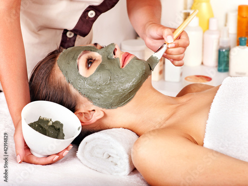 Photo: Clay facial mask in beauty spa. Clay facial mask in beauty spa.