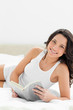 Close-up of a brunette reading a book on her bed