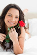 Close-up of a pretty woman holding a rose