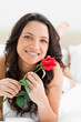 Smiling pretty woman holding a rose