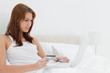 Redheaded woman shopping online on her laptop