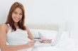 Portrait of a redheaded woman shopping online on her laptop
