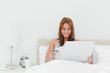 Smiling redheaded using her credit card online