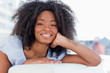 Portrait of a happy woman lying on her sofa