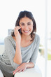 Portrait of a smiling young woman phoning 