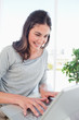 Beaming student using a personal computer