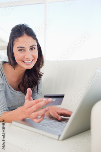 Photo: Portrait of a student using her credit card online Portrait of a student using her credit card online