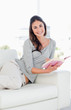 Portrait of a cute brunette reading a novel