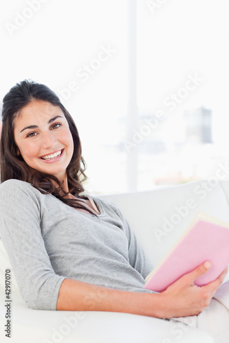 Photo: Portrait of a beaming woman with a novel Portrait of a beaming woman with a novel