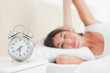 Brunette waking up by her alarm ringing 