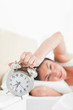 Brunette hating her alarm 