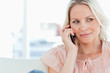 Close-up of a blonde phoning on a sofa