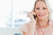 Close-up of a blonde phoning on a divan