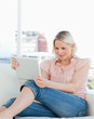 Close-up of a blonde looking at a touchpad