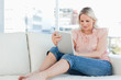 Blonde housewife using a touchpad