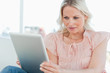 Surprised blonde using a touchpad