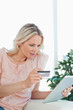 Blonde buying online with a touchpad