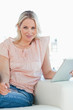 Portrait of a blonde buying online with a touchpad