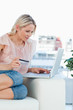 Blonde buying online with a laptop